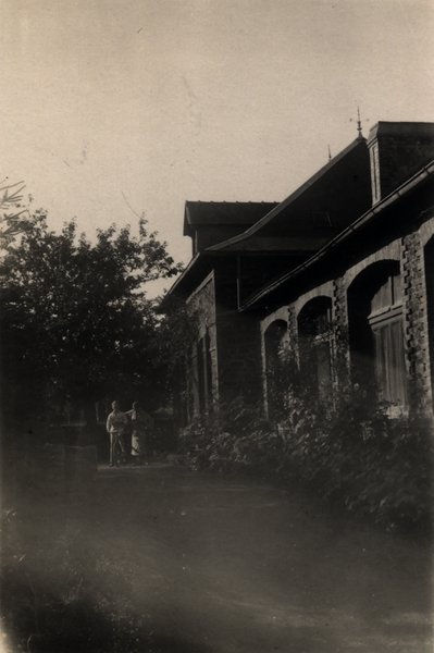 Façade de maison à arcades avec deux silhouettes au crépuscule. Noir et blanc.ᴬᴵ