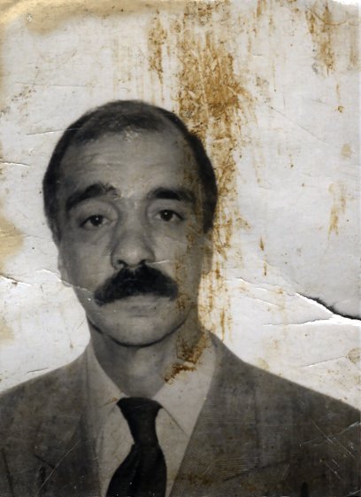 Visage d’homme moustachu en costume et cravate. Noir et blanc.