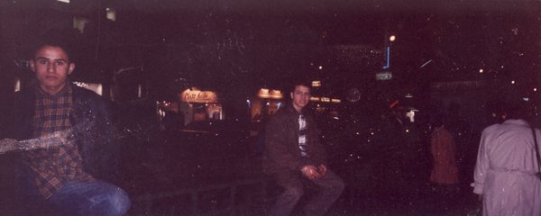 Men sitting in the street at night.