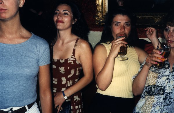 Quatre femmes dans un bar, l'une d'elles buvant un verre.ᴬᴵ