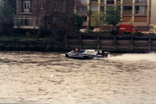 Bateau de course Boutté numéro 10 devant des immeubles d'habitation.ᴬᴵ